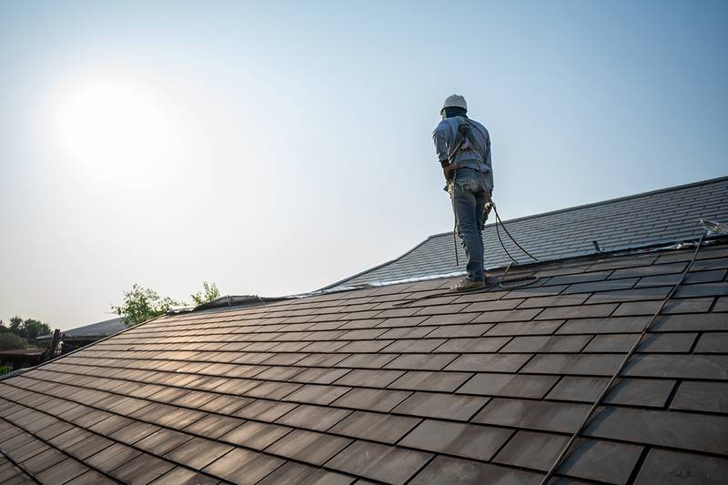 Residential roof with new asphalt shingles on a family home